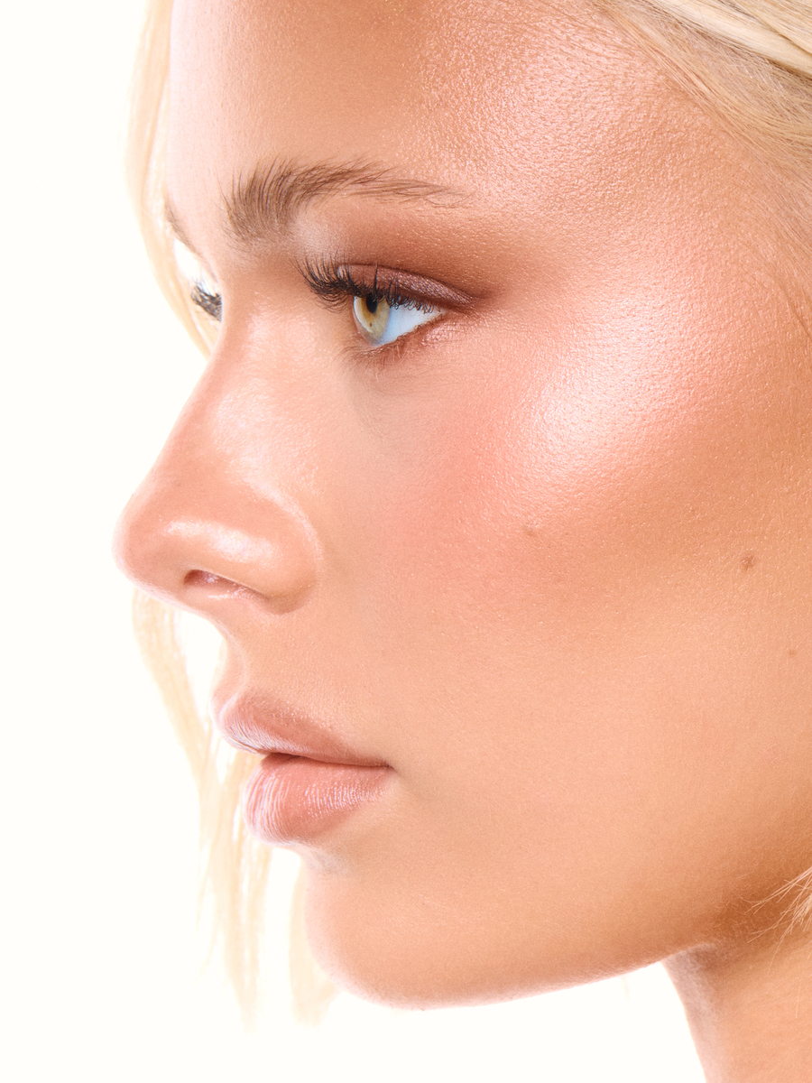Side-profile beauty portrait of a blonde model with glowing skin and soft bronzed Aussie glam makeup, photographed in Miami by Josh Eskridge.